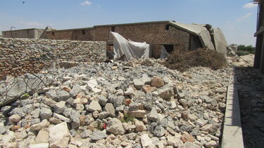 Rubble completely covering a street in a village in Syria