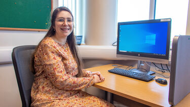 Meryem sat by a computer inside the Health Communication Sciences building