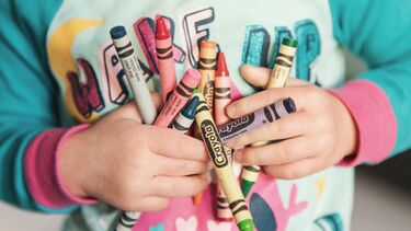 Child holding crayons