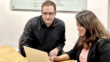 A student working with a member of staff.