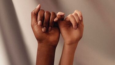 Hands joined together by the little fingers