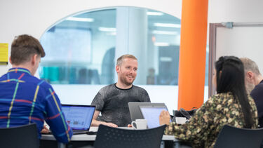 people at table with laptops