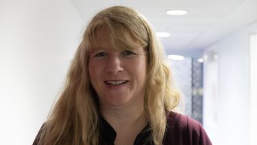 Marian Derbyshire wearing a dark red top.