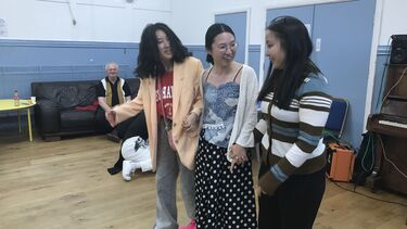 Party guests enjoy the three-legged race