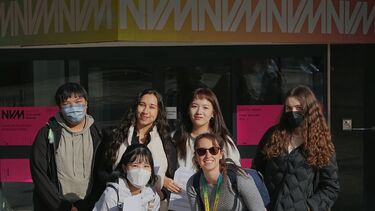 Group posing in front of national video game museum 