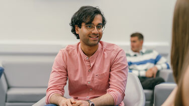 Sahil sat on an armchair.