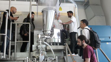 Several people stood in the Diamond Pilot Plant