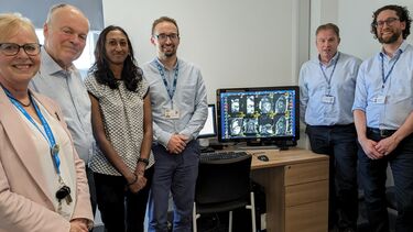 The photo shows Clive Betts MP with the team behind the AI cardiac segmentation tool stood in a group with a computer screen showing the tool in action.
