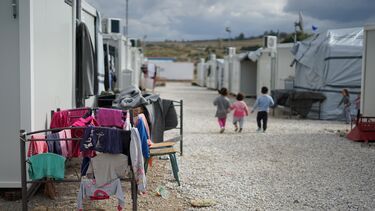 Photo of children walking through a refuge camp