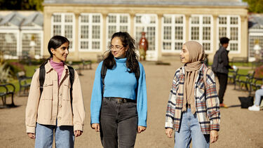 3 undergraduate students walking the Sheffield Botanical Gardens 
