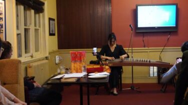 Lingxi Zang performs on the guzheng