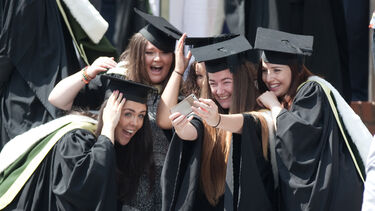 Female graduates taking pictures