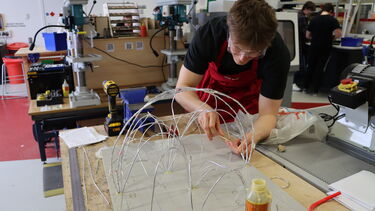 A man working on a wire mesh