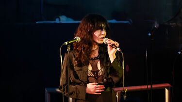 A photograph of singer Coda Galabov at the microphone