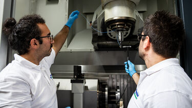 Two people inspecting machinery