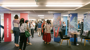 People gathered at presentation at window on Korea event