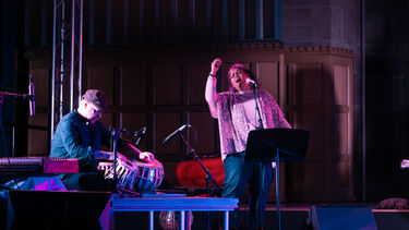 Two musicians on stage playing indian music 