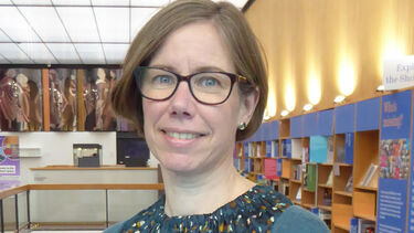 Anna Grigson stands in Western Bank Library