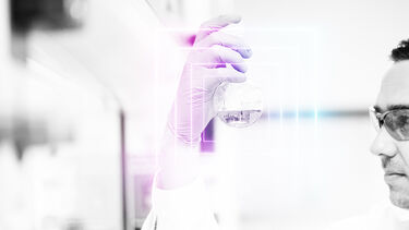 person looking at round bottom flask