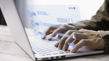 A person interacting with a chatbot on their laptop