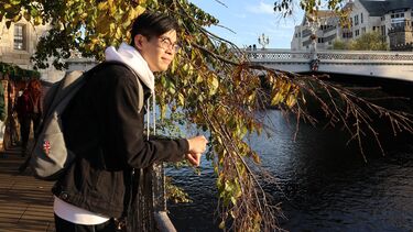 Terry Wu looking over a river.