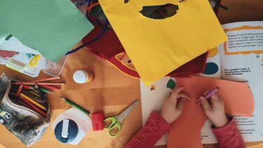 Image of a young person working on a collage assignment