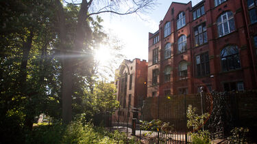 A traditional red brick building on a sunny day. 