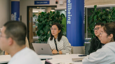 A group of students sitting round a table for a workshop
