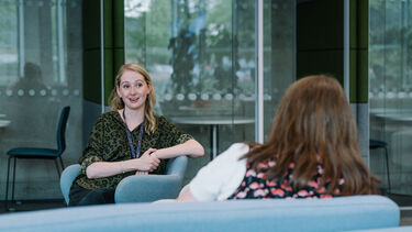 Two women sitting across from each other in The Cornerstone