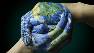 pair of hands painted as the globe