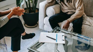 Image of two people sitting on sofas in therapy setting