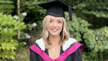 A woman in a graduation cap and gown