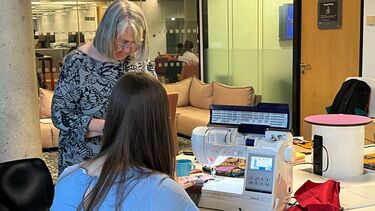 Using sewing machines in the library. 