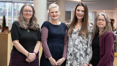 A group shot of the four lead coordinators of the Established Researcher Forum in the Wave building.