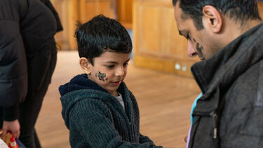 Young boy talking to an adult