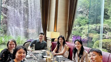 Alumni guests at Management School meet on front of a waterfall up in Seoul July 2023