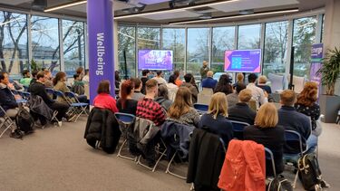 Presentation in large room with screens 