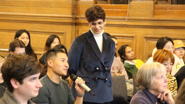 Surabhi is taking a question from the audience the member is holding a microphone 