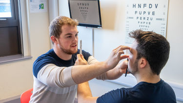 Orthoptics students practising clinical skills on each other