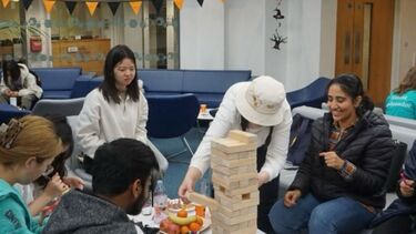 Kanak Soni playing Jenga at a social