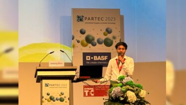 Yashodh Karunanayake presenting in front of a PARTEC banner