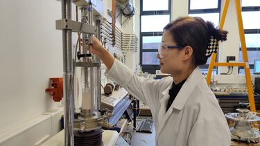 A researcher performing a uniaxial compression test