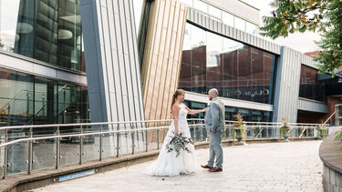 A couple on their wedding day outside of SU