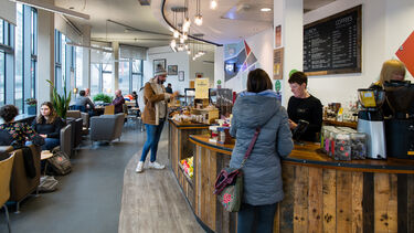 People sat eating and drinking in a cafe