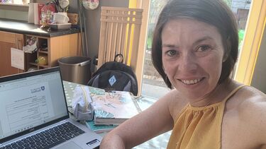 A woman in front of a laptop