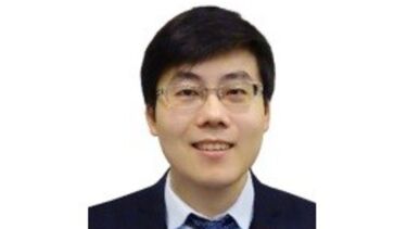 Headshot photograph of Jun Wang