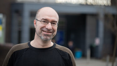 Mark Ariaans, Co-Chair of TechNet, standing in front of a University building