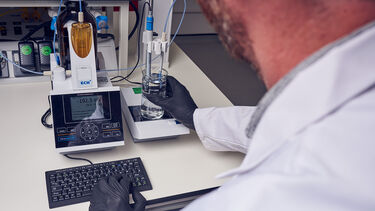 A SAF researcher at the University of Sheffield weighing some liquid