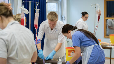 Student nurses practice placing an IV
