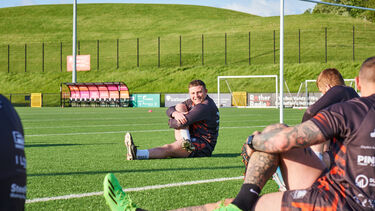 Rubgy player Blake Broadbent practing on the pitch 